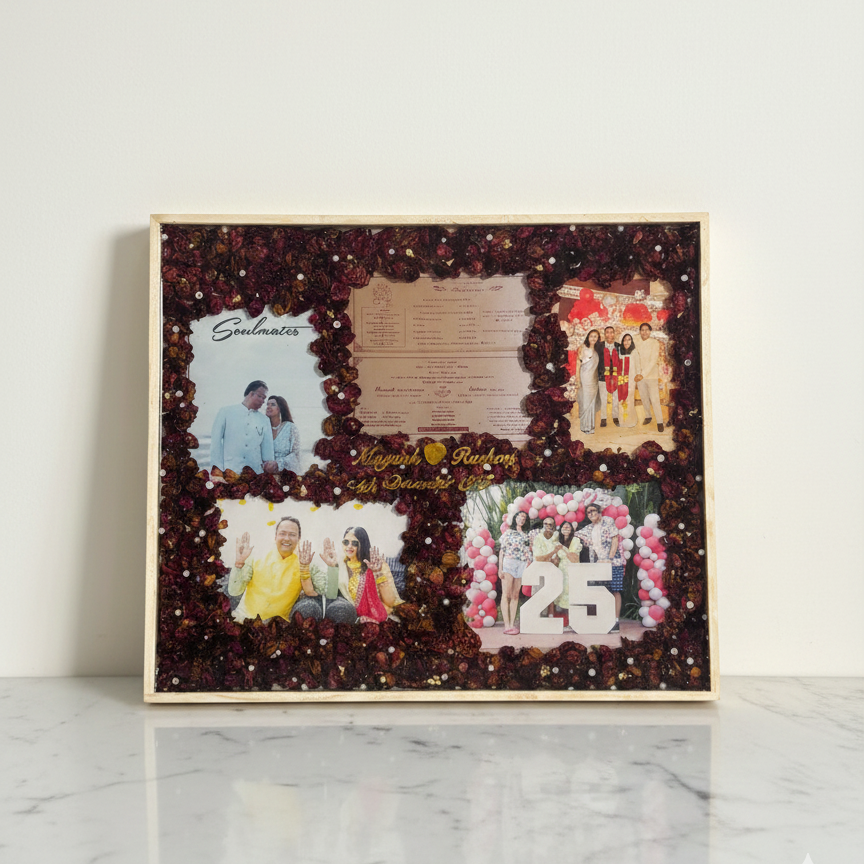 Handcrafted resin photo frame with preserved flowers, wedding photos, and anniversary collage displayed on a marble surface.